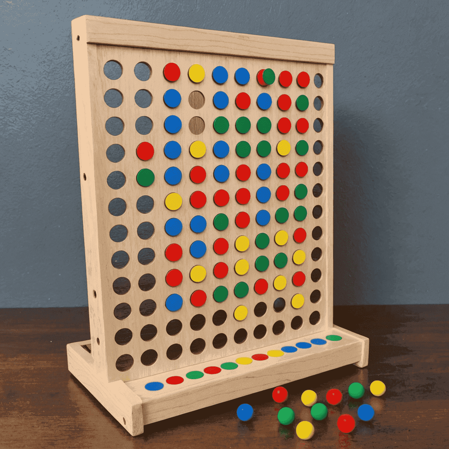 A completed DIY Plinko board with colorful pegs and a disc in mid-drop, showcasing the game in action